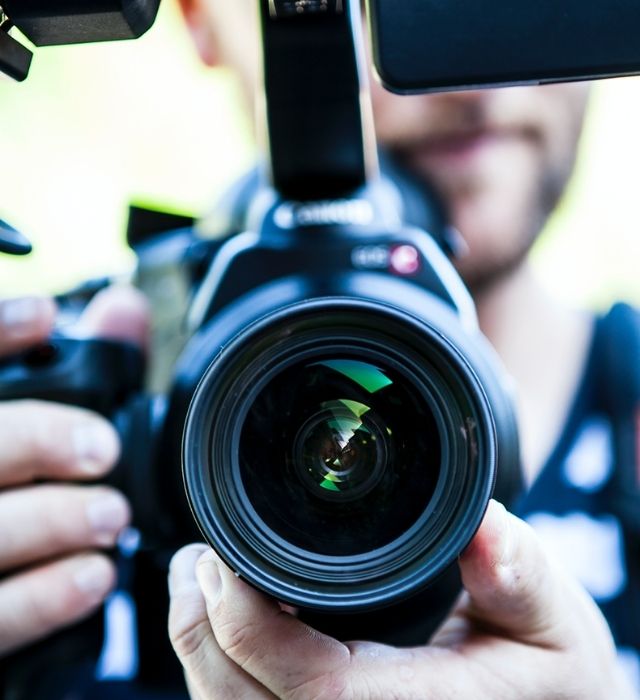 Close up image of a video camera lens used for video advertising in NH